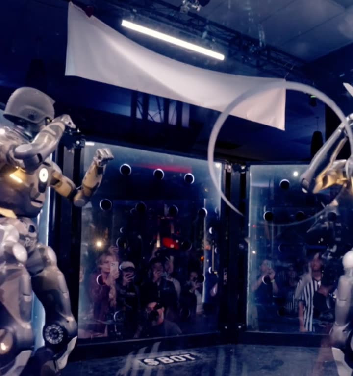 Robots battling inside the REK2 cage